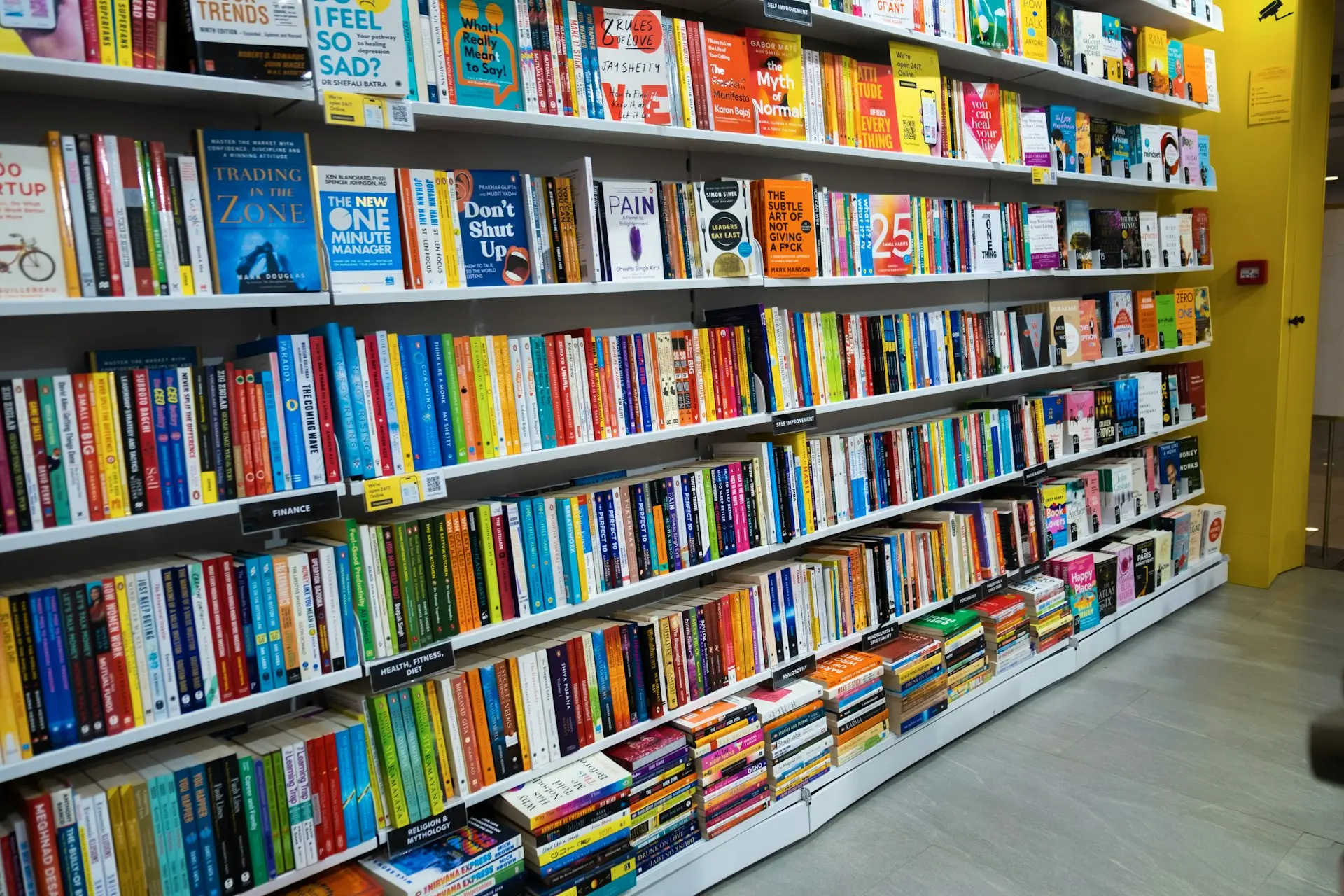 a bookshelf filled with lots of colorful books